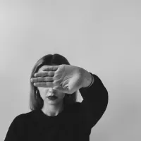 Jeune femme cachant son visage avec sa main © Say thanks 🙌 Give a shoutout to Bekah Allmark on social or copy the text below to attribute. Photo by Bekah Allmark on Unsplash