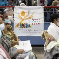 Une banderole sur laquelle est écrit “Synode 2021-2023” est accrochée dans l'assemblée, lors de la célébration de la messe chrismale au Palais des sports de la ville de Créteil. Créteil, 12 avril 2022. © Corinne SIMON / Hans Lucas.