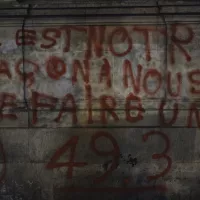 Un tag contre la réforme des retraites à l'occasion des manifestations du 1er mai, à Paris. ©Lucas Boirat / Hans Lucas