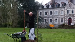 Frère Benoît plante un mimosa, signe d'une nouvelle page à écrire à Timadeuc ©RCF Sud Bretagne