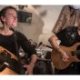 Titre de Galaxie musique sur fond orange de rubrique Culture avec en illustration centré et droite une vielle marron sur un ensemble de flûtes traditionnelles épaisses en bois