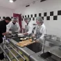 2019 Lycée Val de Saône - Trois élèves et leur maître professionnel dressant des feuilletés d’escargots sauce estragon pour un groupe de chefs d’établissement des Antilles.